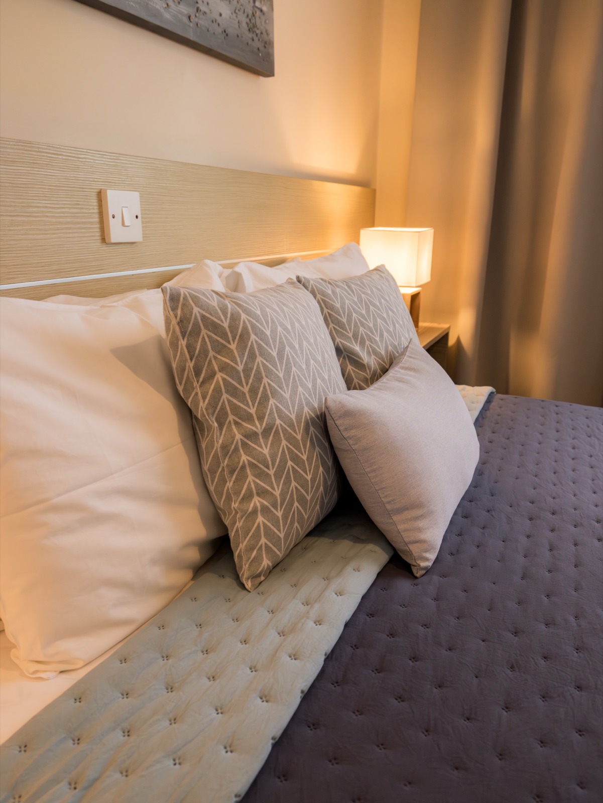 Luxury pillows and warm bedside lighting