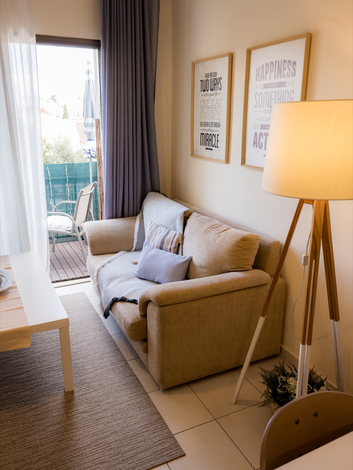 Cozy sofa area with balcony door and motivational art
